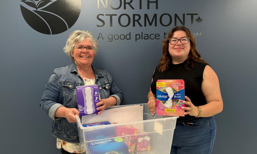 Olivia Leroux, United Way SDG representative and Carol Hunt from the Township of North Stormont holding a box of menstrual products as part of the Period Promise Campaign